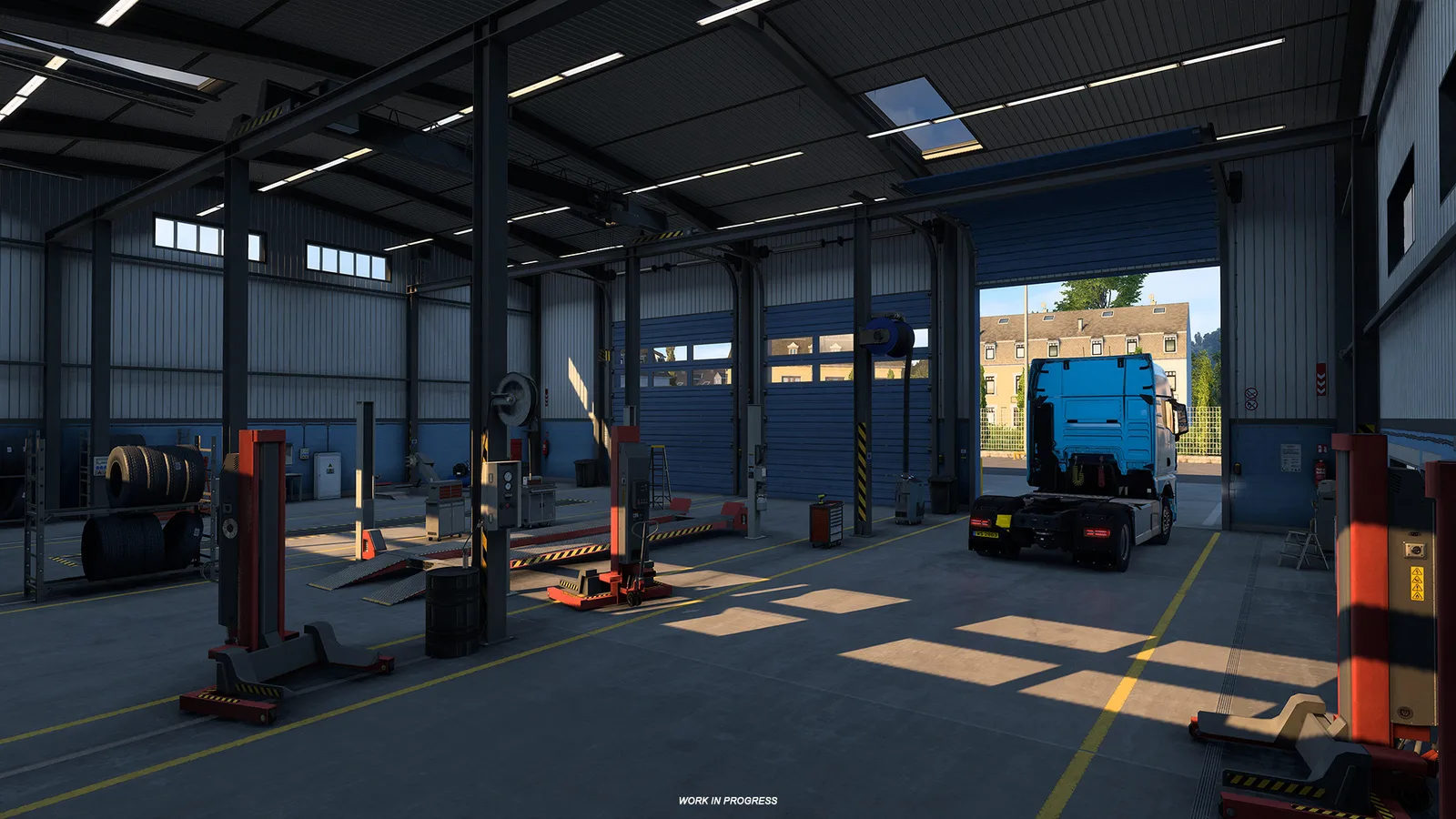 Neu gestaltete Truck-Garage mit blauen Rolltoren, davor eine türkisfarbene Sattelzugmaschine